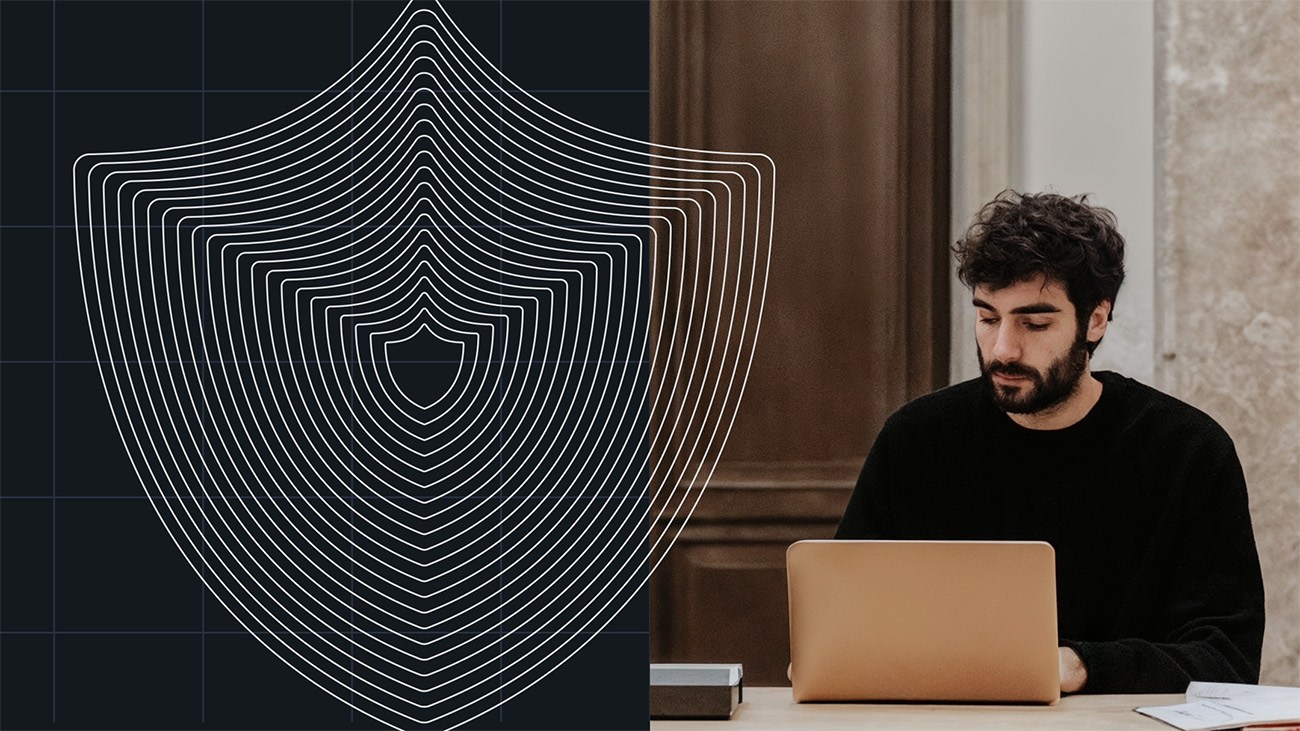 A man works on a laptop beside a digital shield graphic symbolizing cybersecurity and the importance of output escaping.