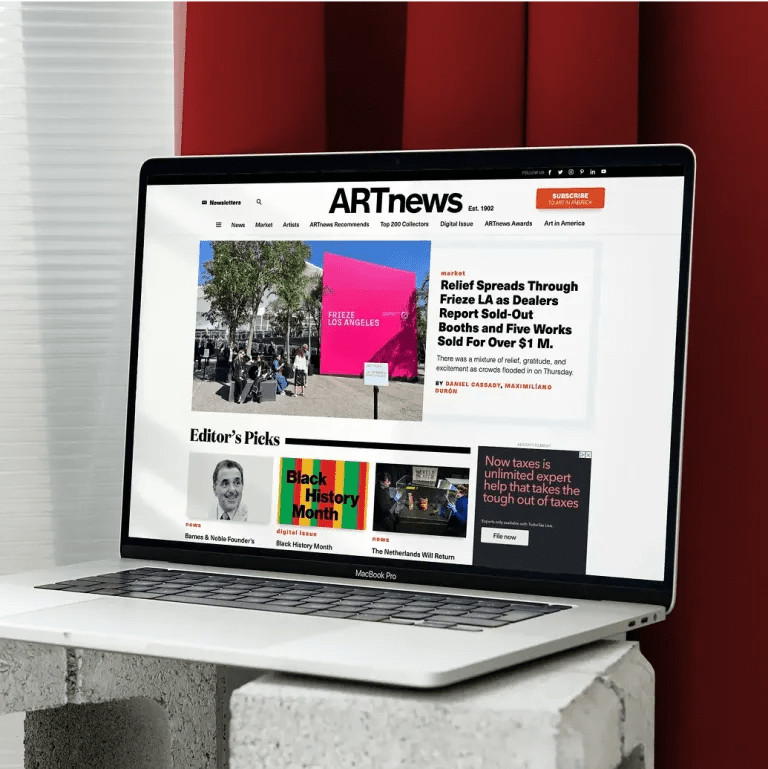 Laptop showing the ARTnews homepage with headlines, editor’s picks, and a feature on Frieze LA.