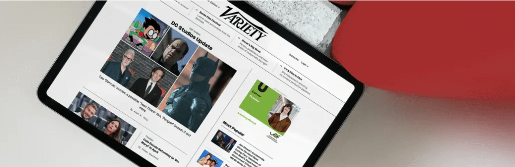 Tablet displaying the Variety website with headlines, celebrity photos, and entertainment news.