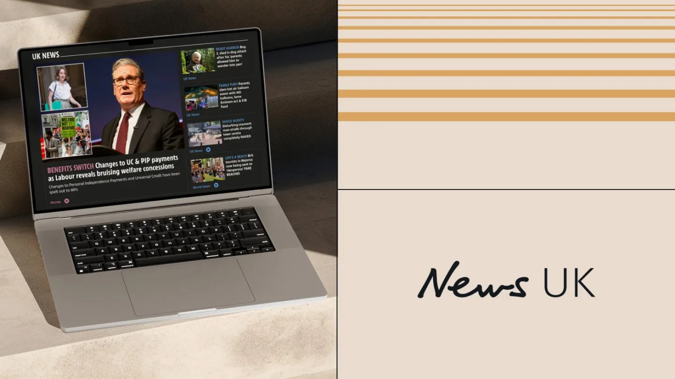 Laptop displaying the News UK homepage with breaking headlines, next to the News UK logo on a beige and gold-toned branded background.