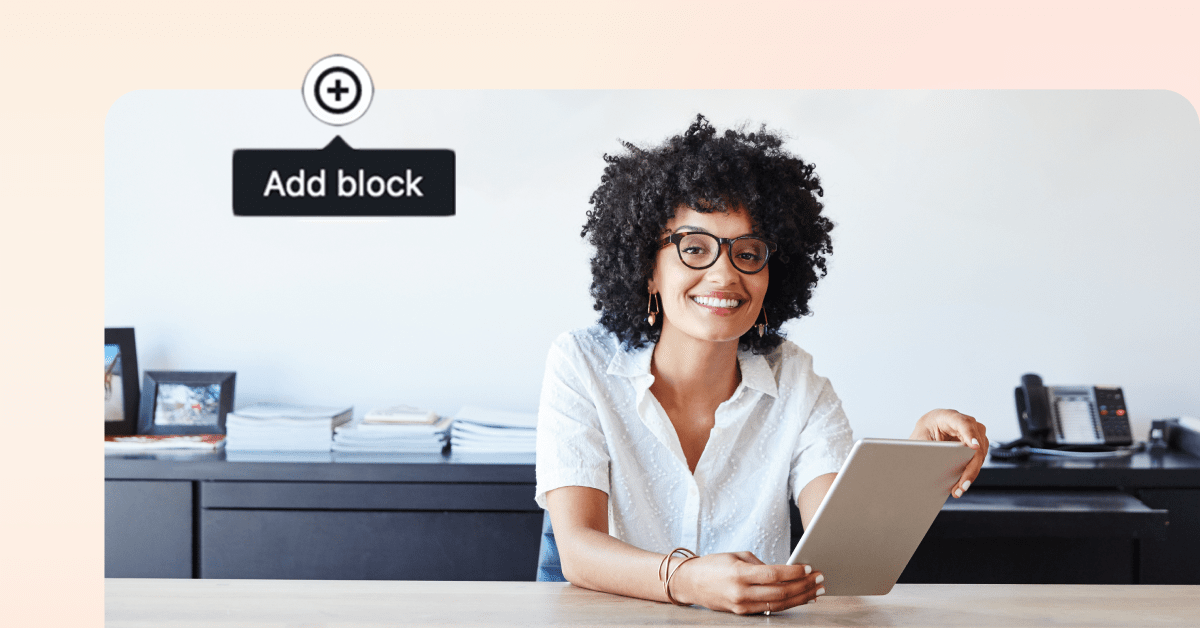 Smiling woman with curly hair holding a tablet, adding content on a digital solution.