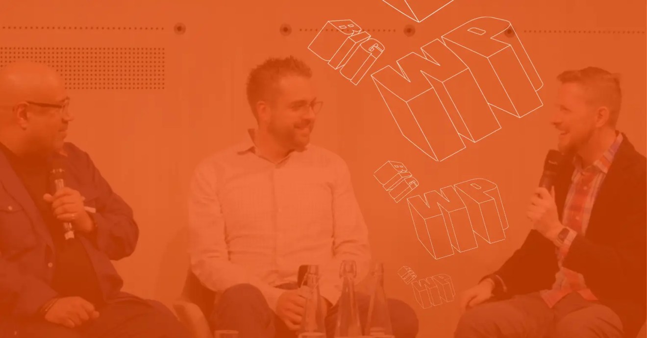 A photo of Matt Mullenweg, co-founder of WordPress and CEO of Automattic, sat down at BigWP London with his co-founder Mike Little, and Dries Buytaert, founder of Drupal and CTO at Acquia, for a discussion about open source technology.