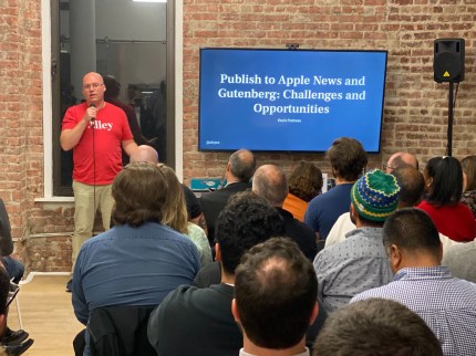 Speaker discusses content publishing challenges and integrations on a digital solution platform to an audience.