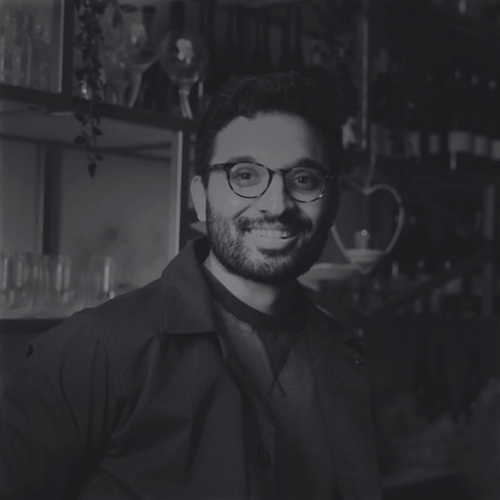 Man with glasses smiling, representing a digital solution dashboard or content workflow scenario.