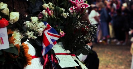 Bouquet with British flag and handwritten notes, highlighting content tribute on a digital solution platform.
