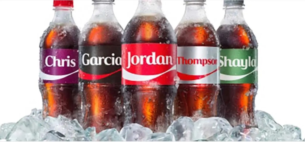 Personalized Coca-Cola bottles illustrating content customization for a digital solution experience.