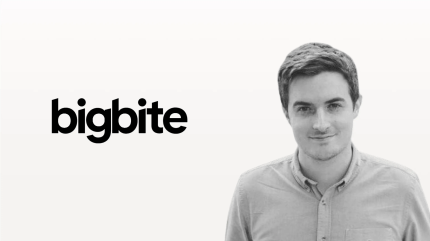 Man standing beside bigbite logo, representing digital solution for content integration or publishing.
