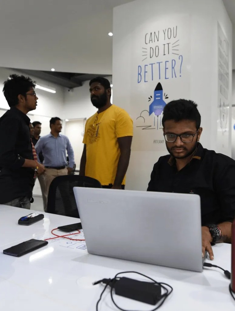People working & discussing in rtCamp office