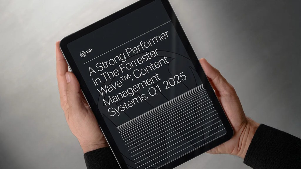 Tablet displaying Forrester Wave™ Q1 2025 report, recognizing WordPress VIP as a Strong Performer in enterprise content management systems.