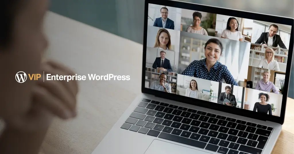 A person looking at a laptop screen that has other people communicating virtually with the WordPress VIP logo