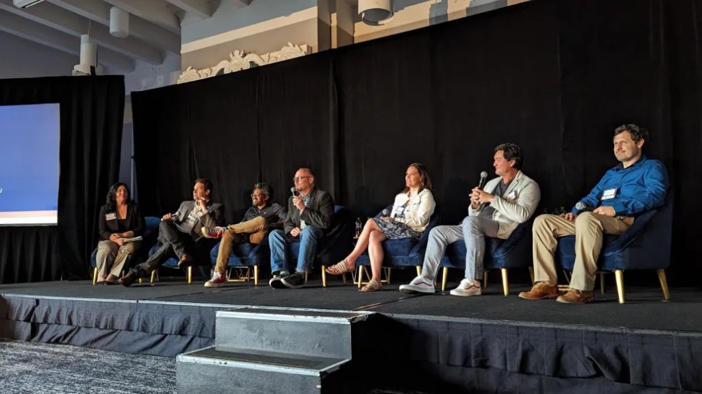 people sitting in a row on a stage