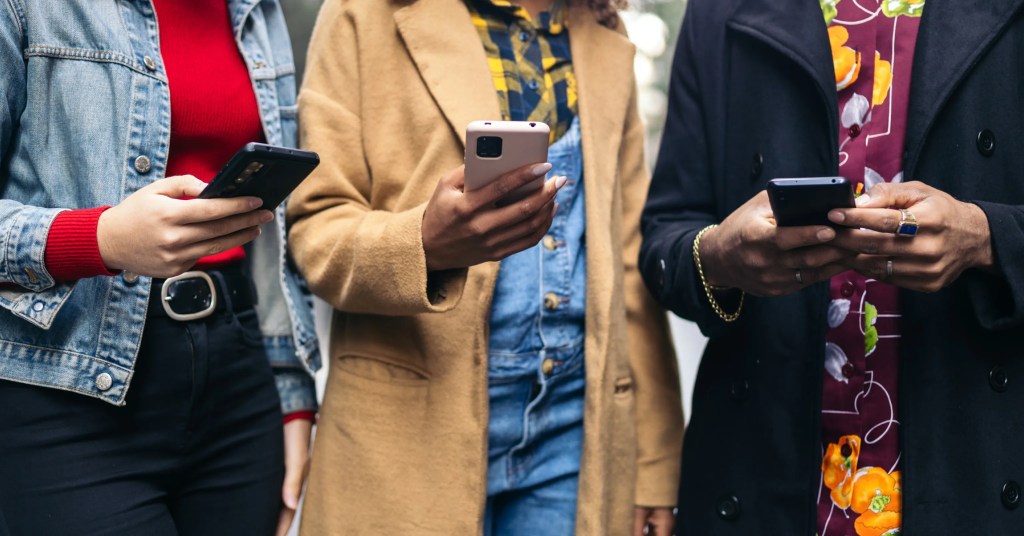 Three people using smartphones to manage digital solution content or editorial workflows.