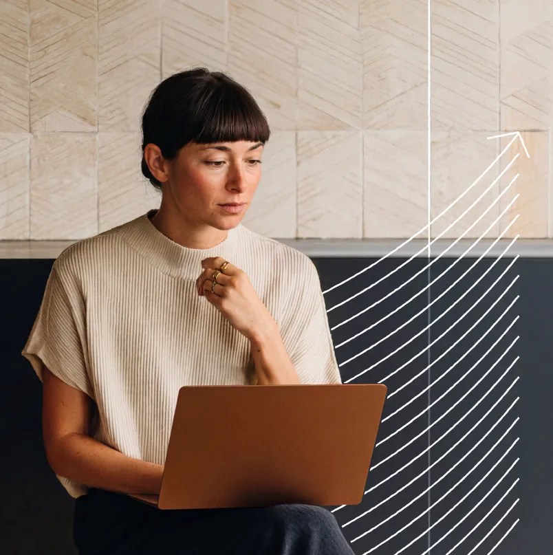 Professional using a laptop while monitoring website growth and performance trends in an enterprise WordPress environment.