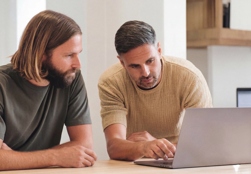 Two colleagues reviewing content together on a laptop during a WordPress VIP support session.