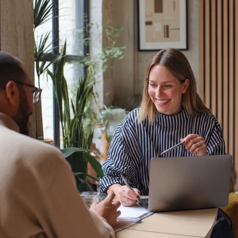 Two professionals collaborating over a laptop during a planning session, representing the architectural collaboration and strategic partnerships that extend the WordPress VIP enterprise ecosystem.