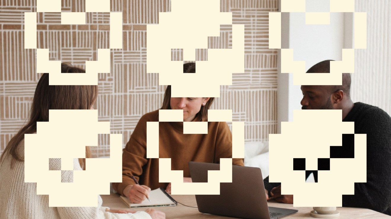 Three people sit at a table with a laptop, partly covered by large pixelated icons, as they discuss AI trust and contemplate the Future of The Website.